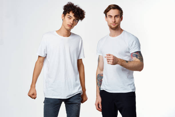 istock two men in t-shirts friendship communication light background 2190716442