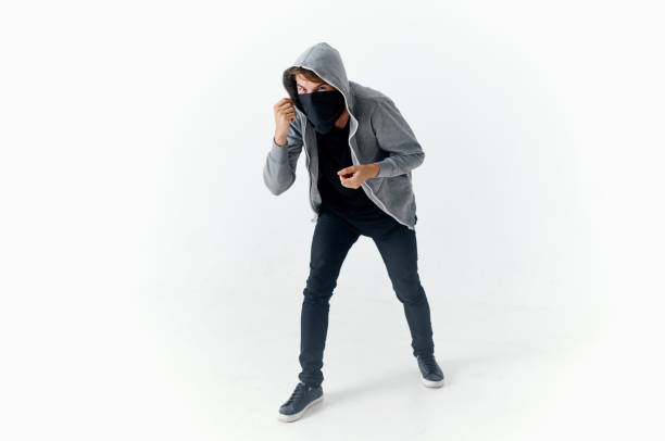 masked hooded man hiding his face theft. High quality photo