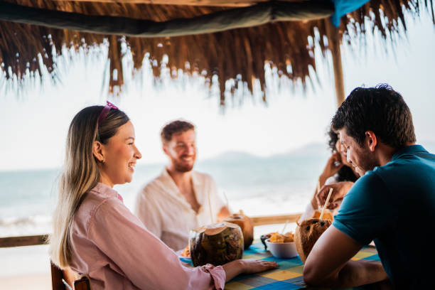 istock Friends talking in restaurant on the beach 2190716878