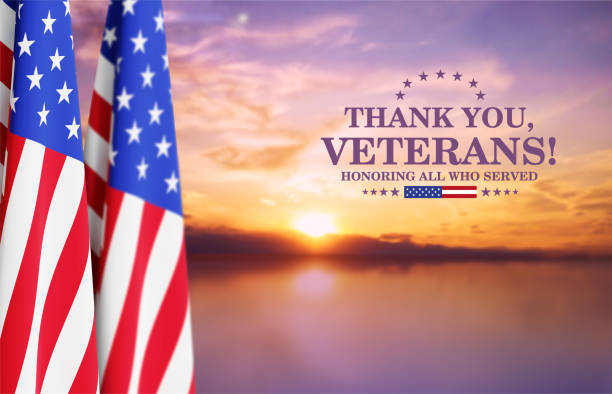 istock Veterans Day Background Design. USA flags against the sunset 2190716881