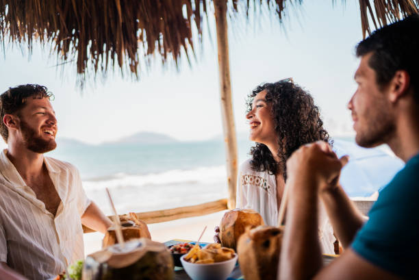 istock Friends talking in restaurant on the beach 2190716892