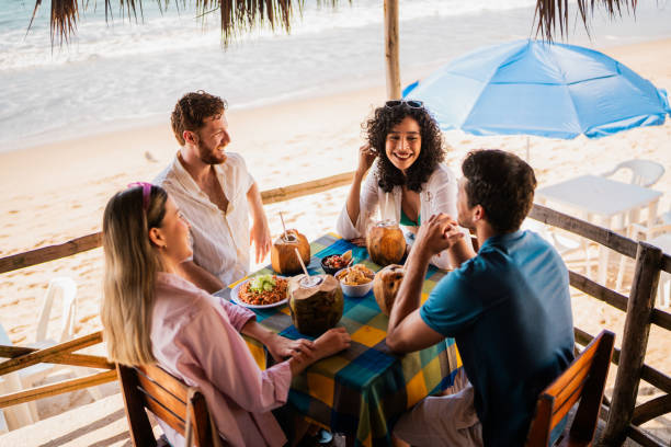Friends talking in restaurant on the beach