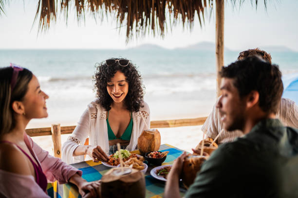 istock Friends talking in restaurant on the beach 2190716936
