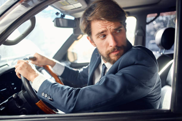 istock bearded man in a suit in a car a trip to work rich 2190716937