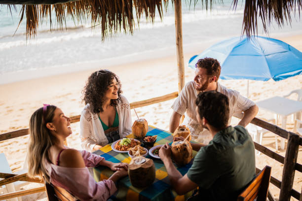 istock Friends talking in restaurant on the beach 2190716942