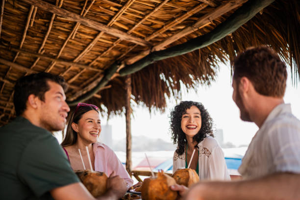 istock Friends talking in restaurant on the beach 2190716977