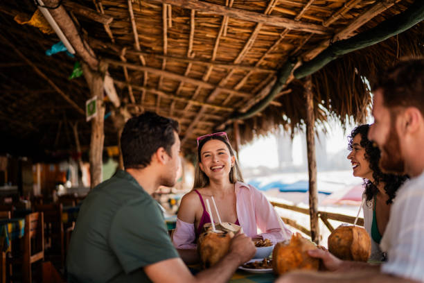 istock Friends talking in restaurant on the beach 2190717006