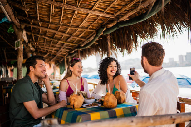 istock Friends talking in restaurant on the beach 2190717010