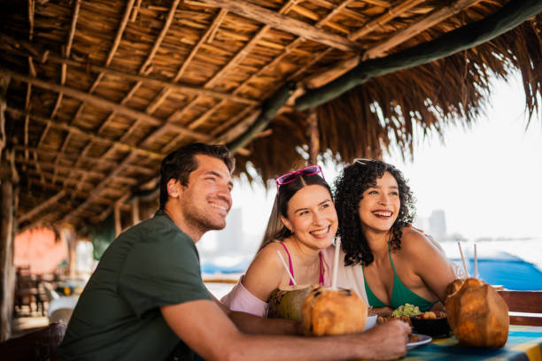 istock Friends posing for photo in restaurant on the beach 2190717027