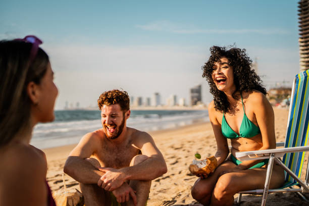 istock Friends talking on the beach 2190717283