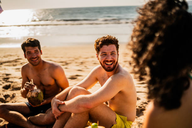 istock Friends talking on the beach 2190717293