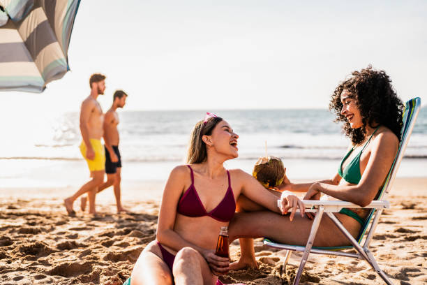 istock Friends talking and relaxing on the beach 2190717366