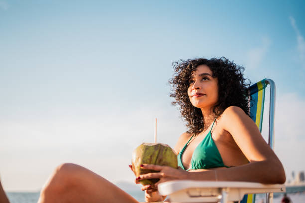 istock Young woman contemplating on the beach 2190717430