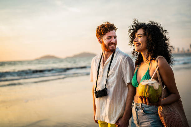 istock Young couple talking and walking on the beach 2190718690