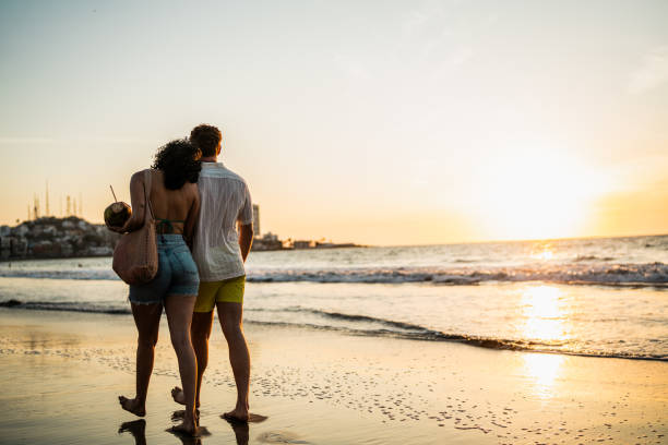 Young couple talking and walking on the beach