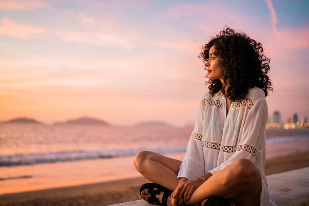 Young woman looking at view contemplating on the beach