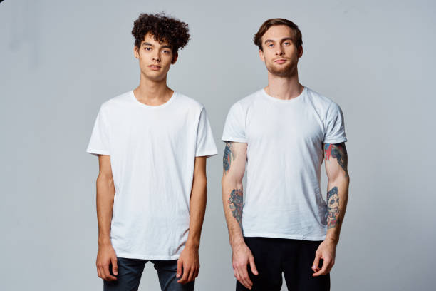 istock two men in white t-shirts emotions friendship fun 2190720924