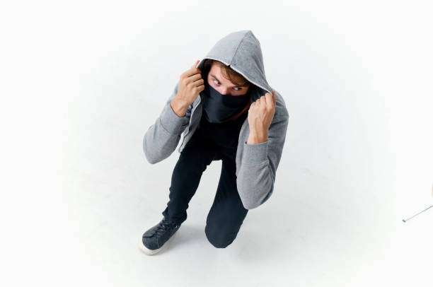 masked hooded man hiding his face theft. High quality photo