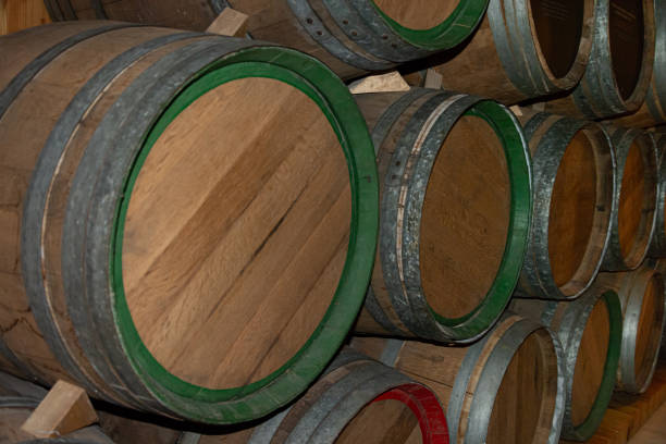 istock wooden barrels in wine cellar for wine 2190721768