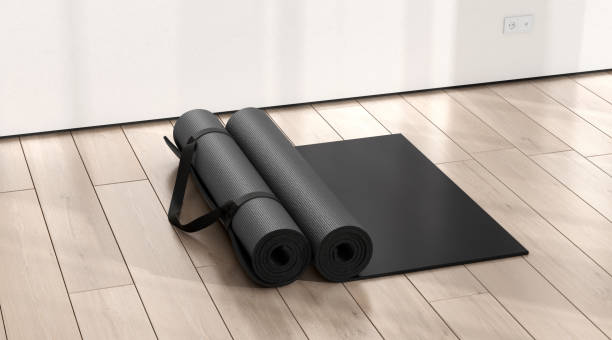 istock Blank black rolled yoga mat on floor shadow mockup 2190722393