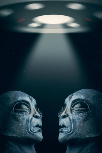 Two aliens, face to face, looking up at their mothership.