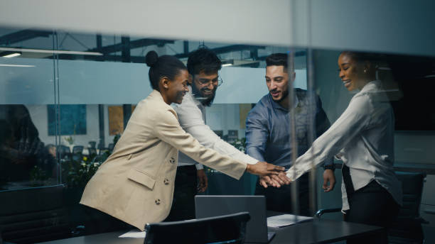 istock Multiracial business team group of workers developers managers looking at laptop in office celebrating success victory good news put palms up partnership unity gesture good investment financial profit 2190724577