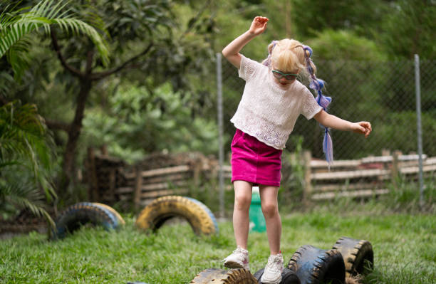 little albino girl with long hair outdoors playing in the playground