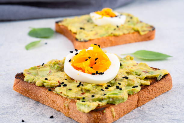 istock Healthy avocado toasts with eggs on table 2190726402
