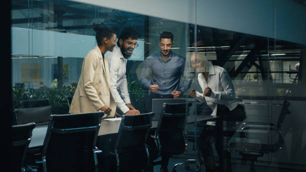 istock Multi-ethnic diverse business team coworkers colleagues corporate partners workers win with laptop celebrating good online result success winning financial growth together united teamwork partnership 2190726448