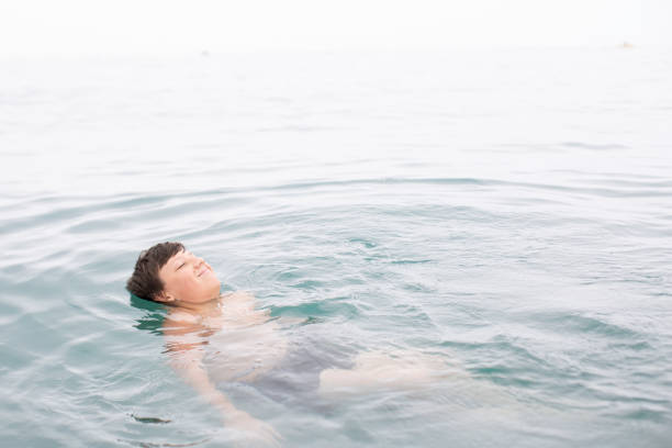 Carefree boy floating in the ocean
