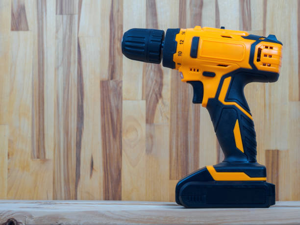 istock A screwdriver-drill against a wood background, ready for work, is ideal for repairs and construction in the country or at home 2190728710