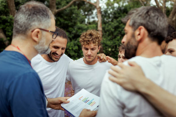 Coach talking strategy with football team