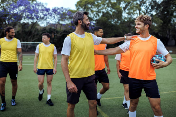istock Soccer players walking together on soccer field during training session 2190730254