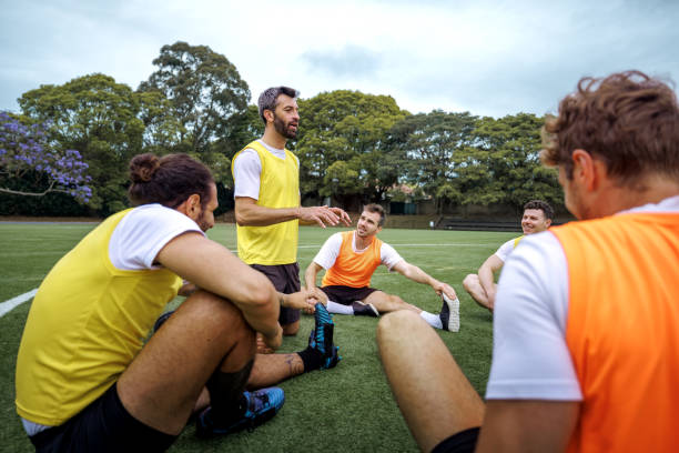 istock Soccer players warming up before training session on soccer field 2190730447