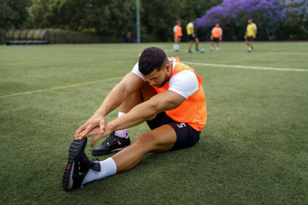 Soccer player warming up on a soccer field during training session