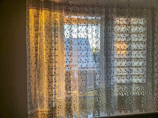 istock Soft light filters through lace curtains, creating a warm and inviting atmosphere in a cozy room. Perfect for interior decoration inspiration. 2190732776