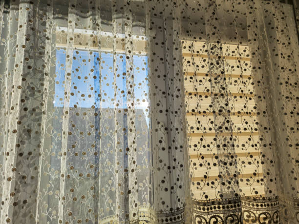 istock Bright sunlight streaming through delicate lace curtains, creating a warm ambiance in a cozy room 2190732777