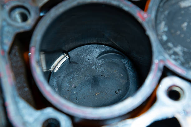 istock An exposed disassembled internal combustion engine. The engine block contains dirty pistons with carbon deposits and broken pieces of metal. The concept of lack of car care and untimely engine service 2190732862