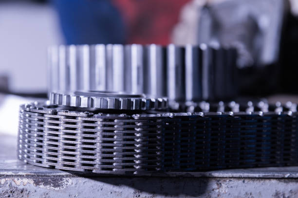 Uninstalled transfer case gear with wide torque chain. Tinted repair image.