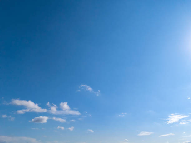 istock A beautiful clear blue sky with scattered clouds and bright sunlight. Perfect for backgrounds or nature-themed projects. 2190733173