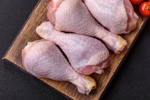 istock Raw chicken or turkey legs with salt, spices and herbs 2190733231