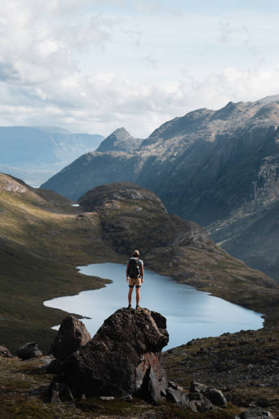 istock Solo Hiker Standing on Rock Overlooking Norwegian Valley and Lake 2190734283