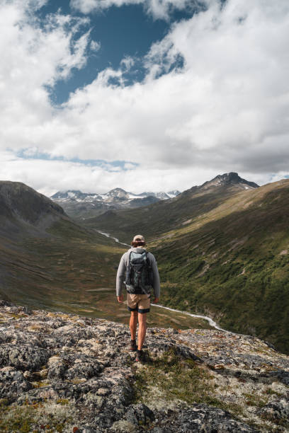istock Trekker Exploring Norwegian Valley with Scenic Mountains and River View 2190734295