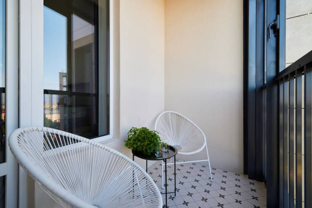 istock A stylish balcony featuring modern chairs beautifully combined with vibrant potted plants 2190734592