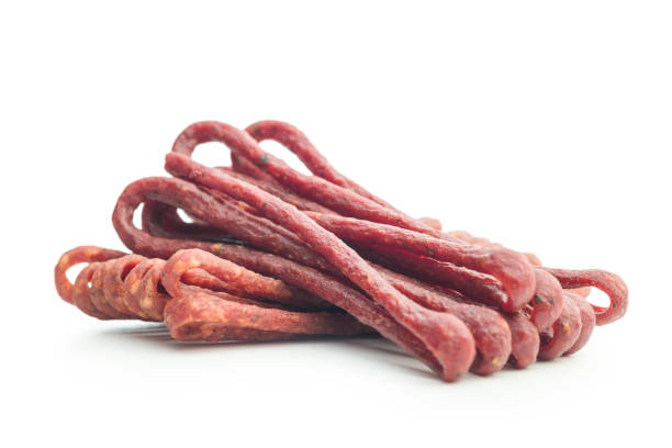 istock Smoked kabanos. Mini dried thin sausages isolated on white background 2190736399