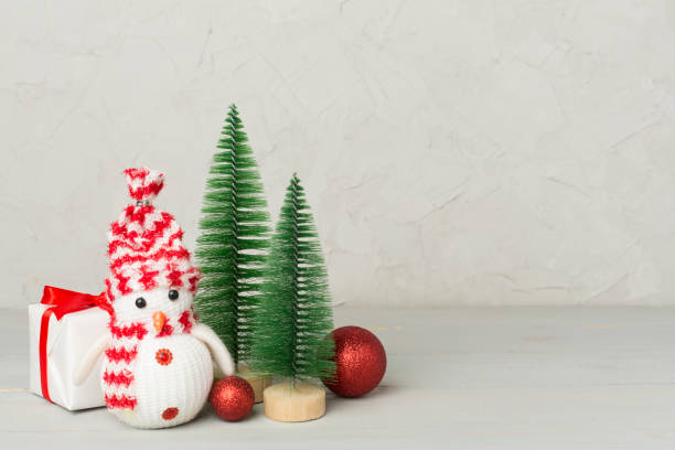 istock Small christmas trees with decoration on wooden table 2190738648