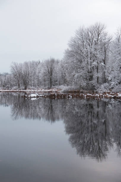 istock Snow Covered Trees Reflected in the Calm water. Winter Landscape. 2190739149
