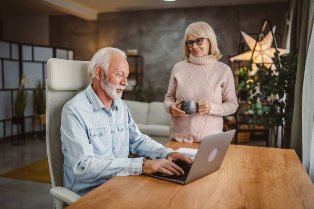 istock Senior wife take care of her husband while she work at home 2190739927