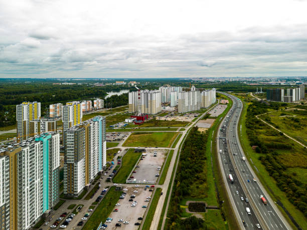 istock An Aerial View Showcasing Modern Urban Development Located Adjacent to a Busy Highway 2190742741