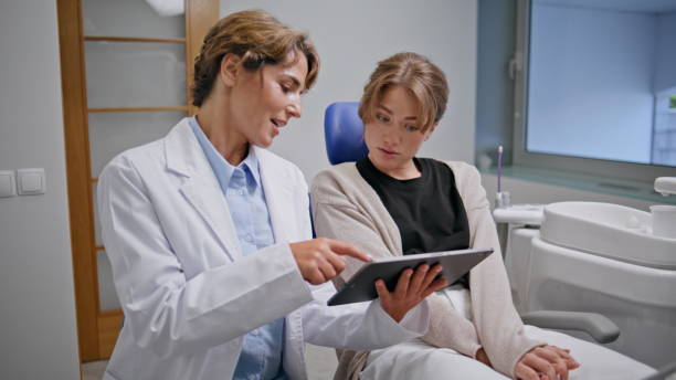 istock Dentistry professional showing tablet with teeth examination to patient closeup. 2190744115